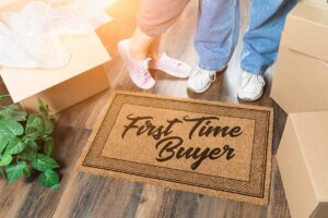 A family labels packed boxes in a bright living room beside a written moving calendar.
